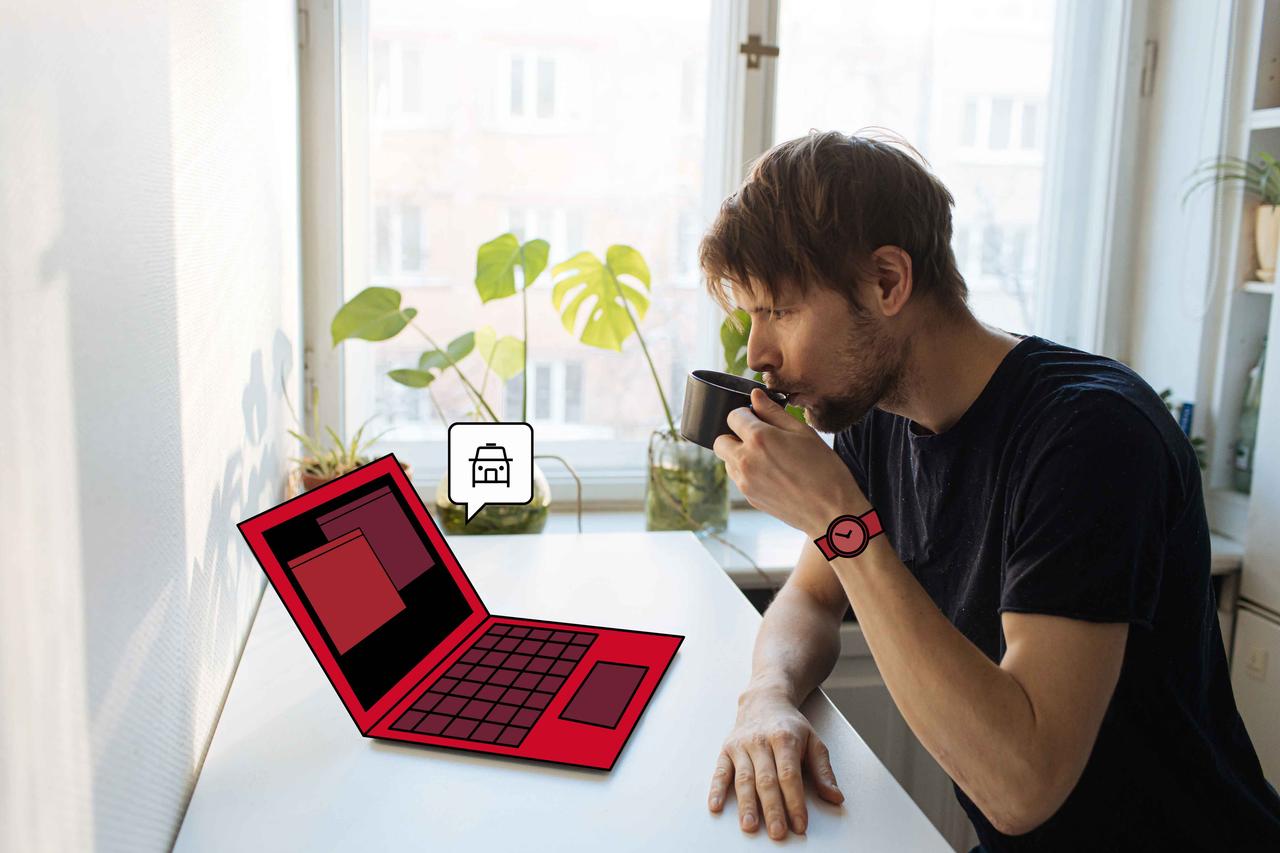 Man drinking coffee at laptop
